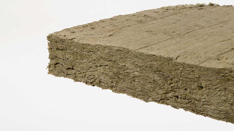 A piece of Mineralwool refractory insulation. This insulation is made of dense, compacted layers of brown material.