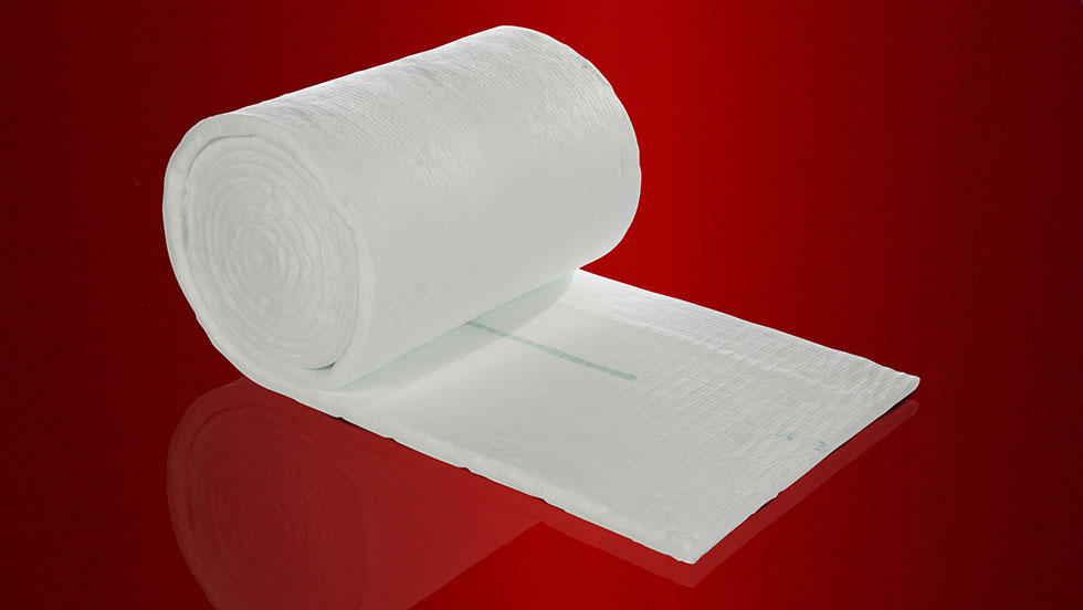 A large roll of Ceramic Fiber Blanket refractory insulation pictured on a red background.